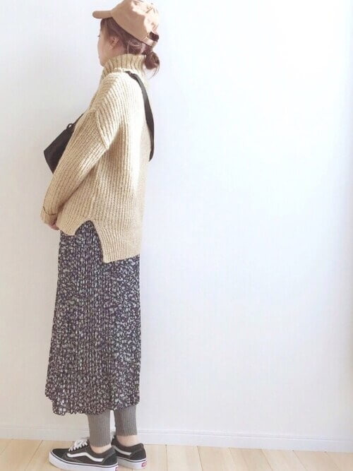 ベージュのタートルネックニット×黒の花柄プリーツスカート×グレーのレギンス